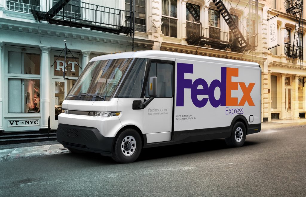A FedEx-liveried BrightDrop EV600 electric cargo van on a city street