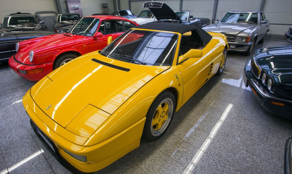 A yellow Ferrari 348 Spider model parked in a showroom in Pomerania, Germany