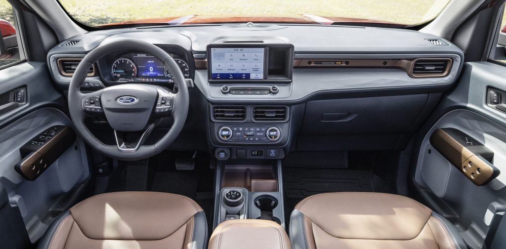 A wide shot of the Maverick's interior with tan upholstery and a wireless charging pad