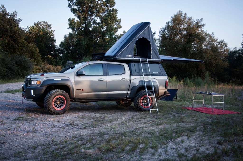 Silver GMC Canyon AT4 OVRLANDX Off-Road Concept with a tent attached to the pickup bed