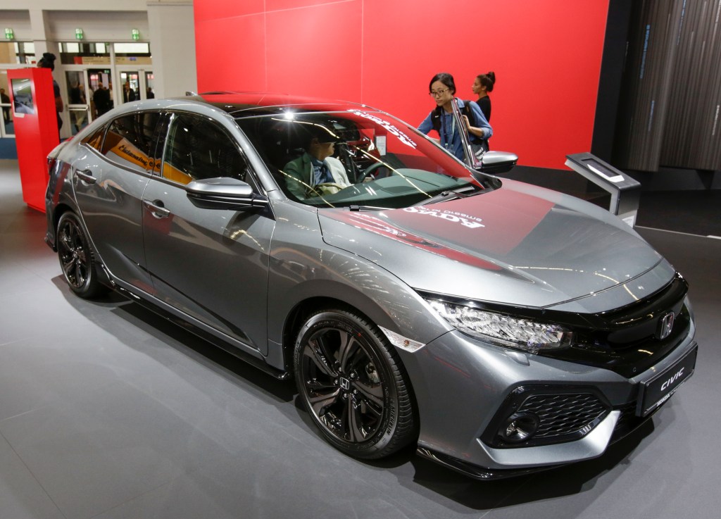 A Honda Civic on display at an indoor auto show is one of the most satisfying 2021 Honda models according to Consumer Reports
