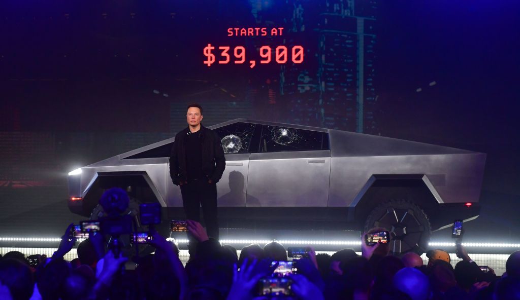 Tesla co-founder and CEO Elon Musk stands in front of the newly unveiled all-electric battery-powered Tesla's Cybertruck