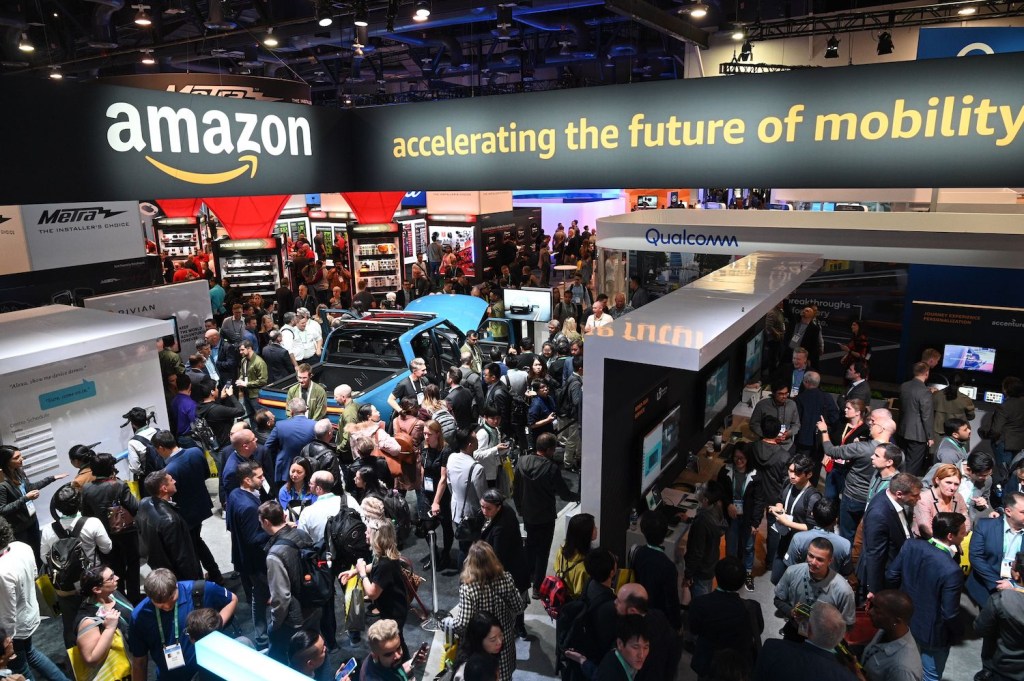 Attendees visit the Amazon booth where a Rivian electric truck with Amazon Alexa integration is displayed, January 7, 2020, at the 2020 Consumer Electronics Show (CES) in Las Vegas, Nevada. (Photo by Robyn Beck / AFP) (Photo by ROBYN BECK/AFP via Getty Images) | Rivian IPO: Backed By Amazon And Ford, Startup Files For $80 Billion