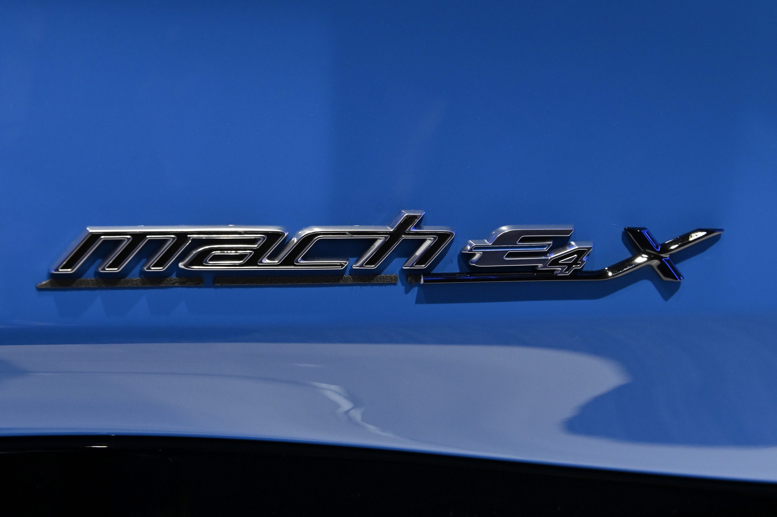 The badge on the blue Ford Mustang Mach E