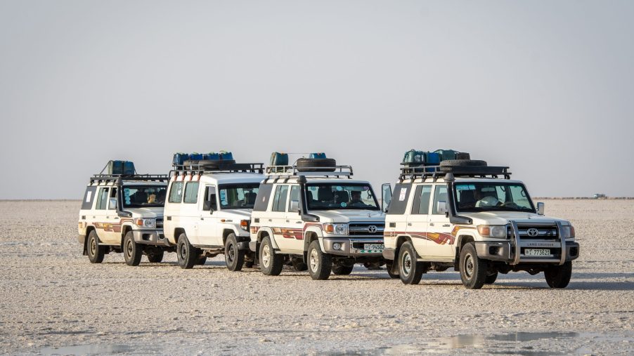 a troop of Land Cruiser J70 Toyota SUVs in that salt flats of Ethiopia.