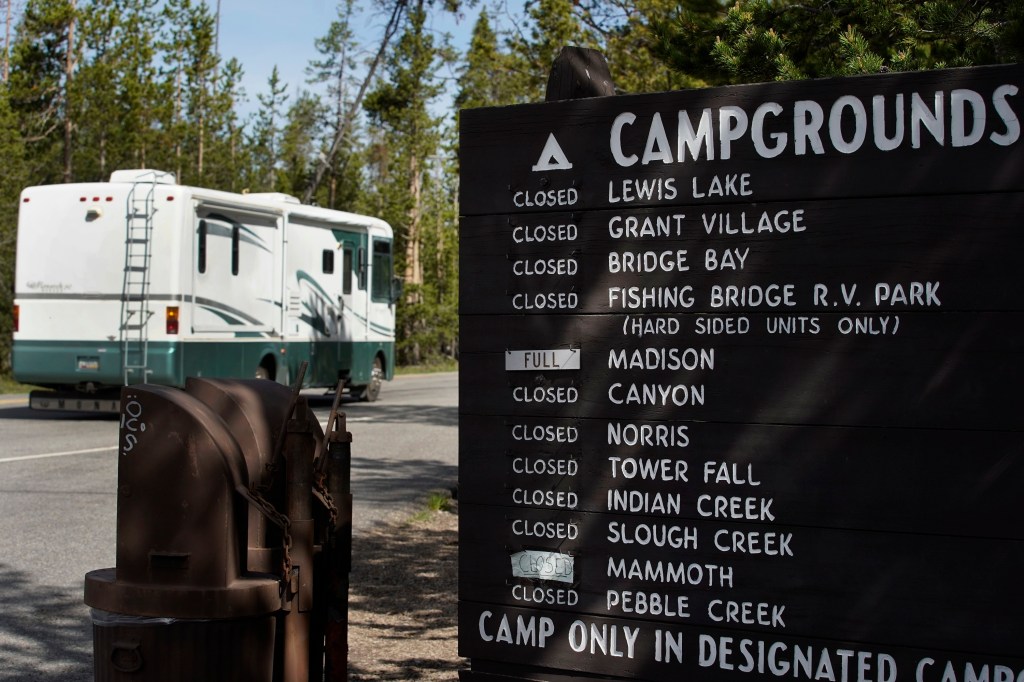 A sign showing full campgrounds in the wake of Yellowstone's re-opening