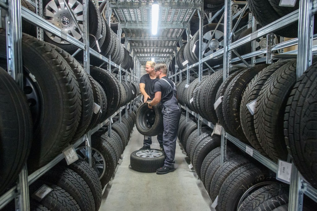 Properly storing your off-season tires can help you save money on winter tires in the long run. 31 July 2020, Saxony-Anhalt, Eilsleben: Rico Skiebe (l), fourth-year apprentice automotive mechatronics technician and his brother Justin Skiebe lifting tyres off the shelves in the tyre warehouse of the Eilsleben car dealership. Justin Skiebe will start an apprenticeship as a car mechatronics technician there on 01 August 2020. In the Magdeburg district of the Chamber of Crafts, a good 820 apprentices will start training in the craft on August 1. That is a good ten percent less than a year ago, the Chamber of Trade announced. Photo: Klaus-Dietmar Gabbert/dpa-Zentralbild/dpa (Photo by Klaus-Dietmar Gabbert/picture alliance via Getty Images)