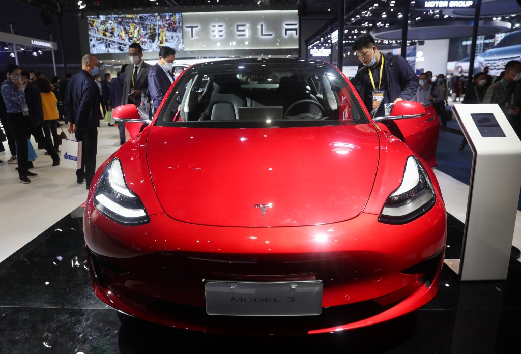 A red Tesla Model 3 electric car is seen at the Automobile exhibition area during the third China International Import Expo CIIE in Shanghai, east China, Nov. 6, 2020.