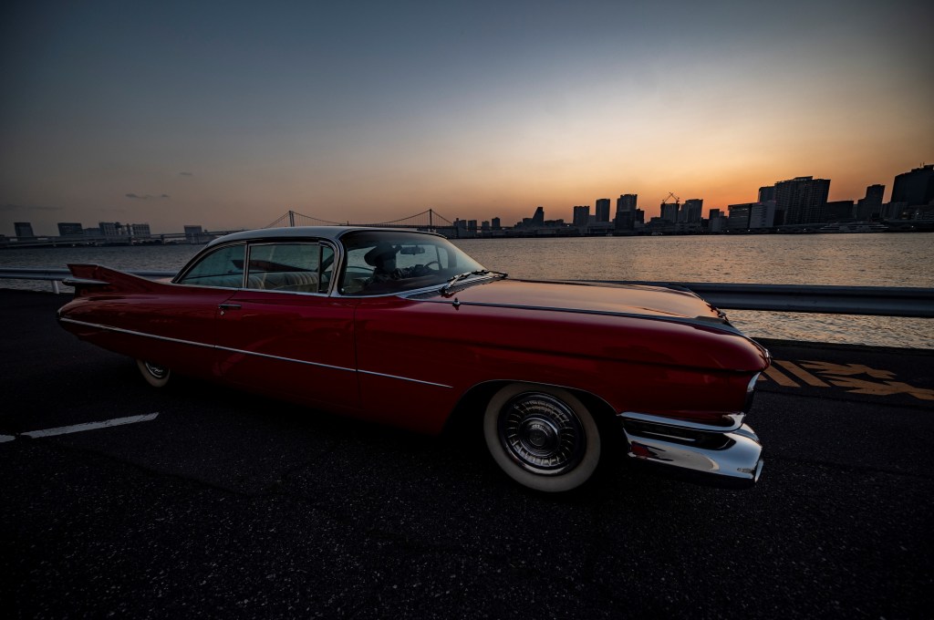 A red 1959 Cadillac Coupe DeVille at sunset in Japan
