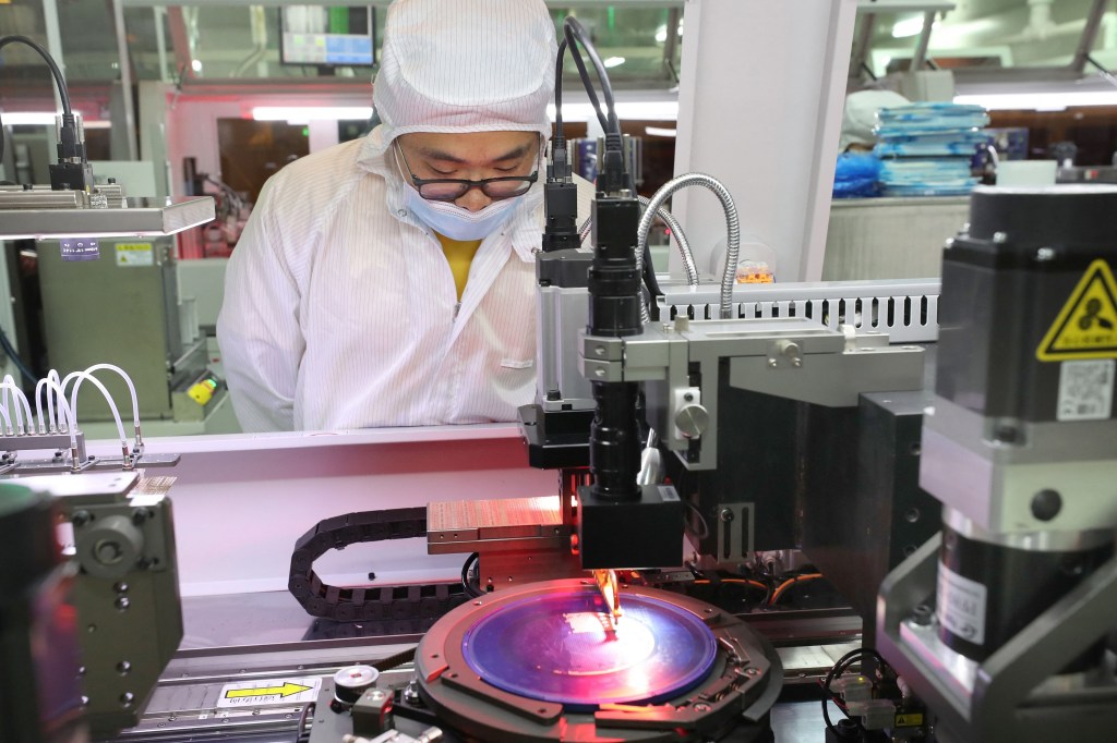 A man in a clean room manufactures semiconductors