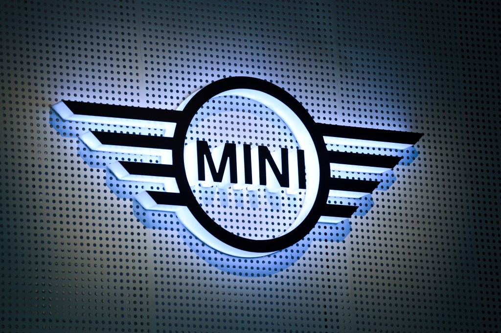 The Mini logo backlit and displayed on a wall