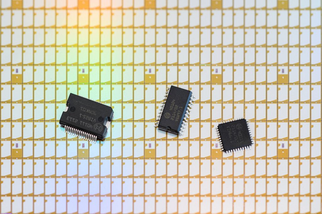 Black semiconductors on a table in a factory. Semiconductor chips are used in the majority of existing electronic devices.