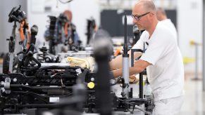 A man assembles a VW EV in a plant in Germany