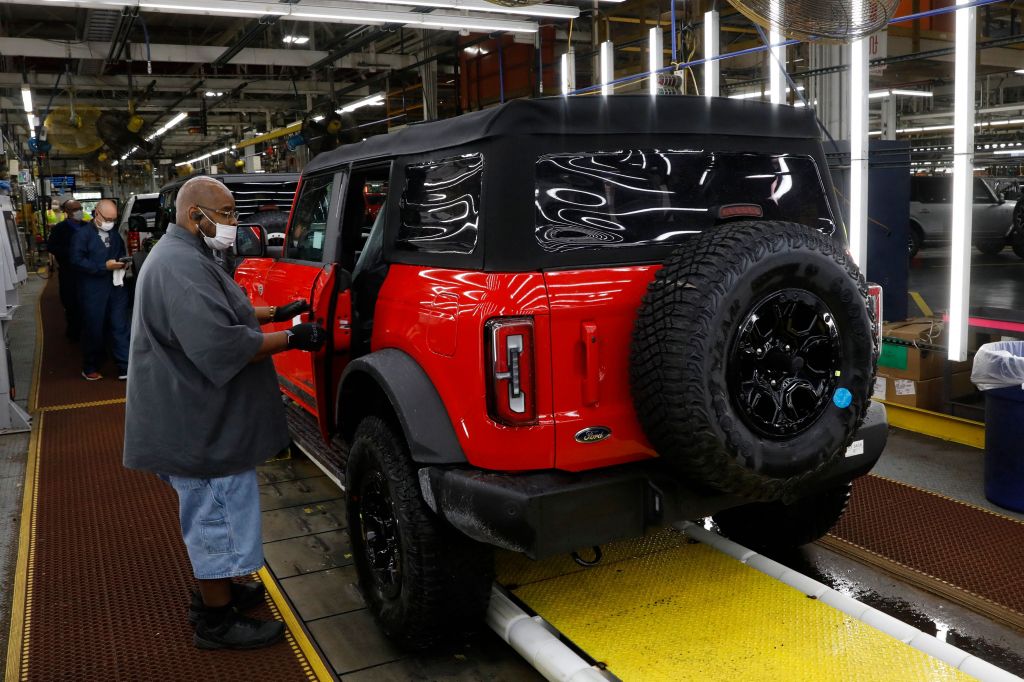 A red Ford Bronco getting parts on the production line. 