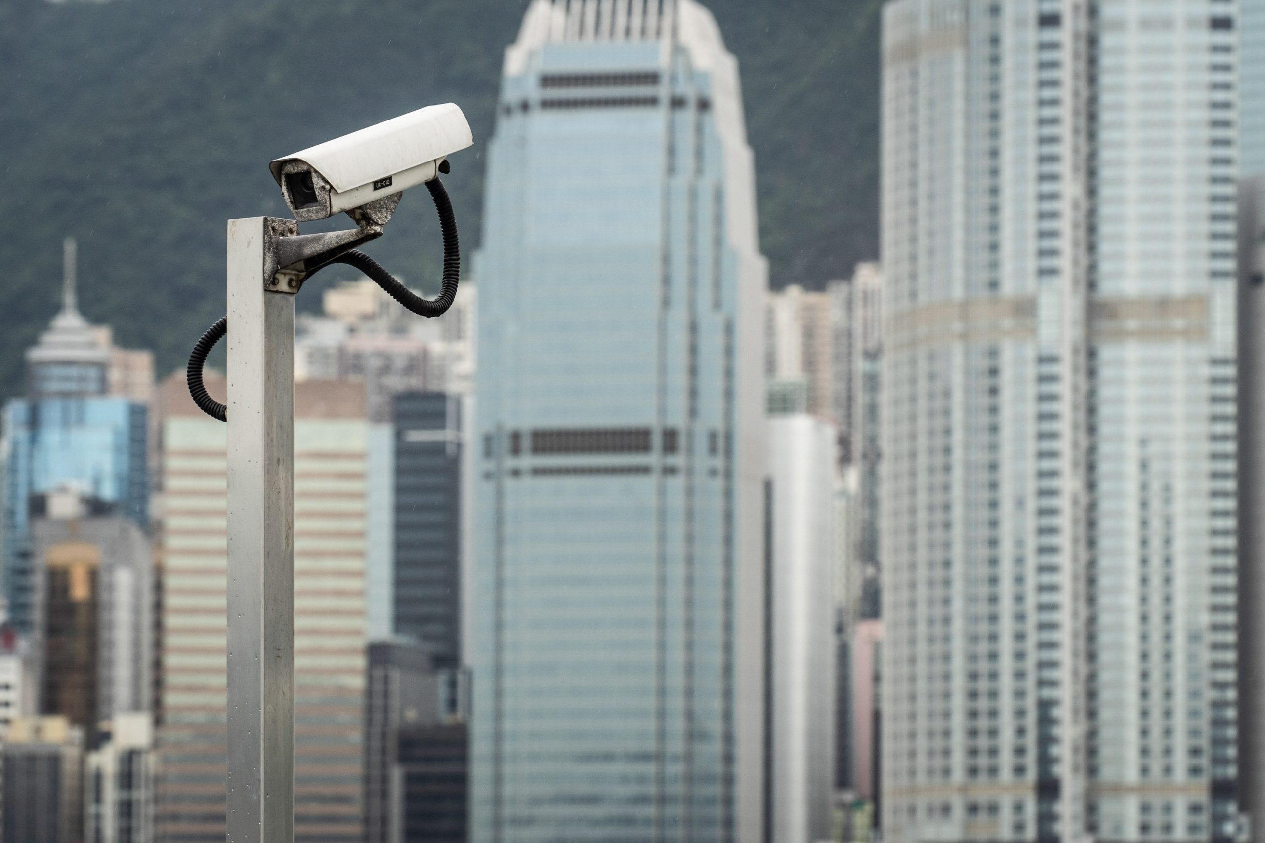 A surveillance camera outlined against a China city skyline