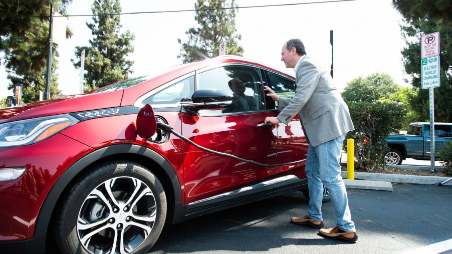 Congressman Adam Schiff plugs in his Chevy Bolt during the unveiling of new electric vehicle charging ports in Downtown Burbank on Monday, July 12, 2021.