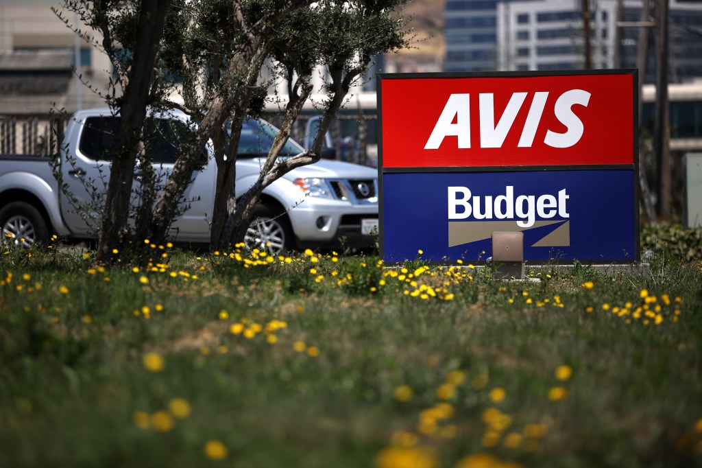 An Avis/Budget sign outside a location in San Francisco, CA