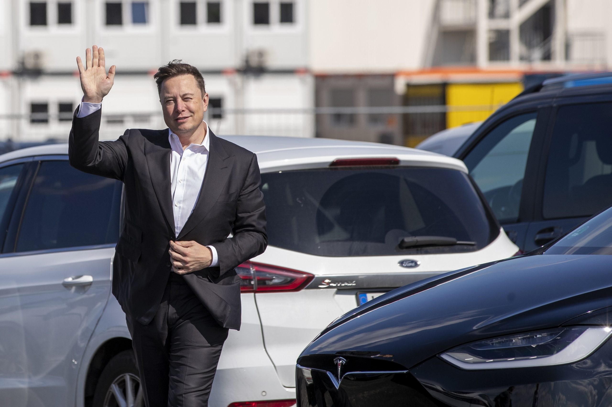 Elon Musk waves to photographers in Germany