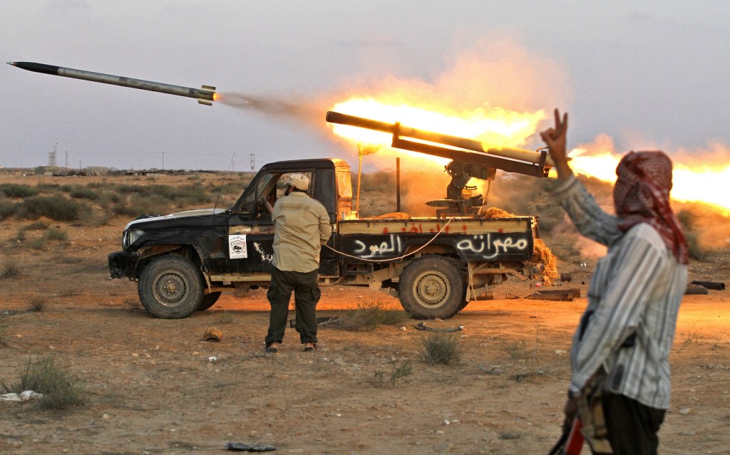 Fighters in the Mideast launch a Grad rocket off the back of a Toyota truck