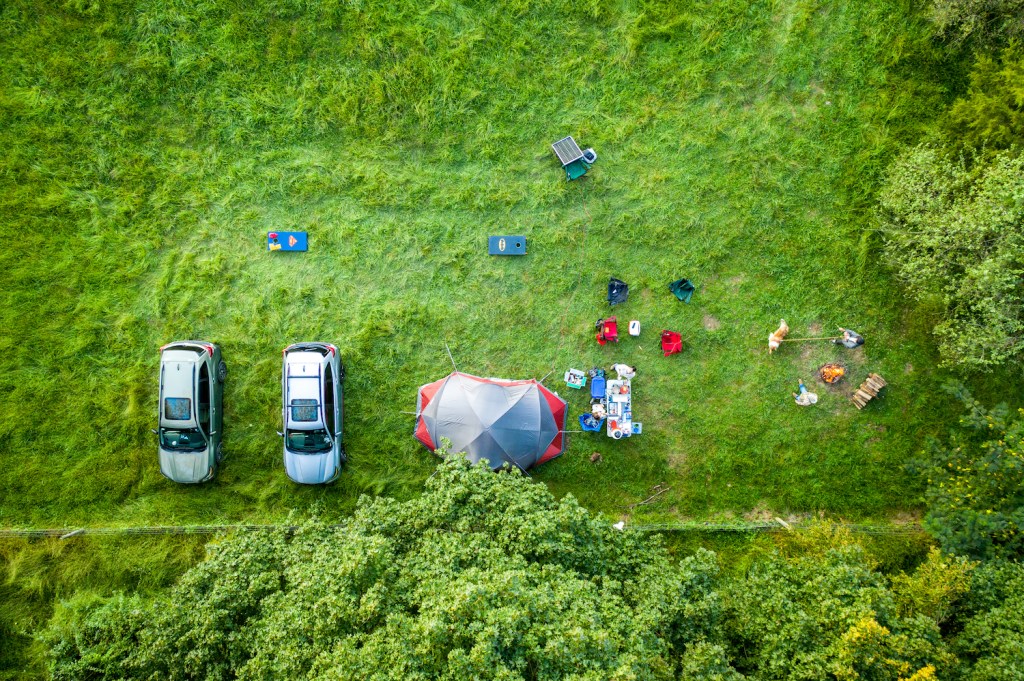 Overland Camping Shelter Options: Hipcamp campers hanging out tent camping in farm fields on the weekend. (Photo by: Edwin Remsberg/VW PICS/Universal Images Group via Getty Images)