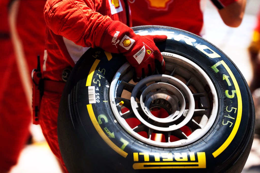 A Scuderia Ferrari mechanic wearing fireproof suit and gloves holding a Ferrari F150˚ Formula One car front wheel and Pirelli P Zero tyre in the pit lane during a tyre and wheel changing pit stop during the 2011 European Grand Prix, Valencia Street Circuit, Valencia, Spain, on the 26th June 2011. (Photo by Darren Heath/Getty Images). Our Tire Speed Rating Chart.