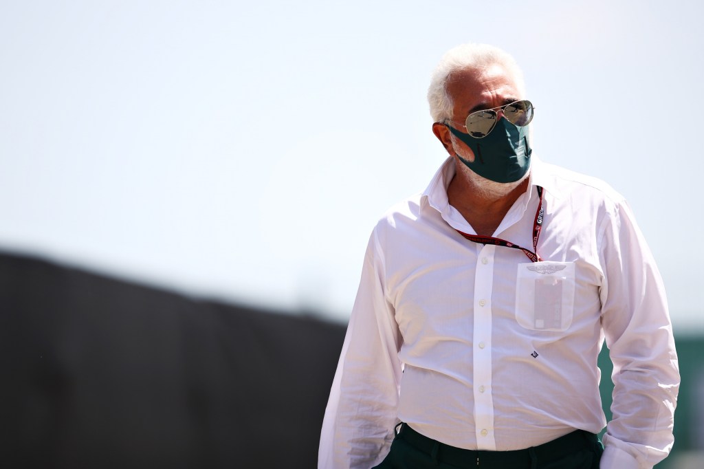 Aston Martin F1 team owner Lawrence Stroll walking in the paddock at Silverstone