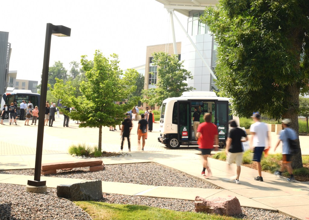 Students at the School of Mines board an AvCo autonomous vehicle