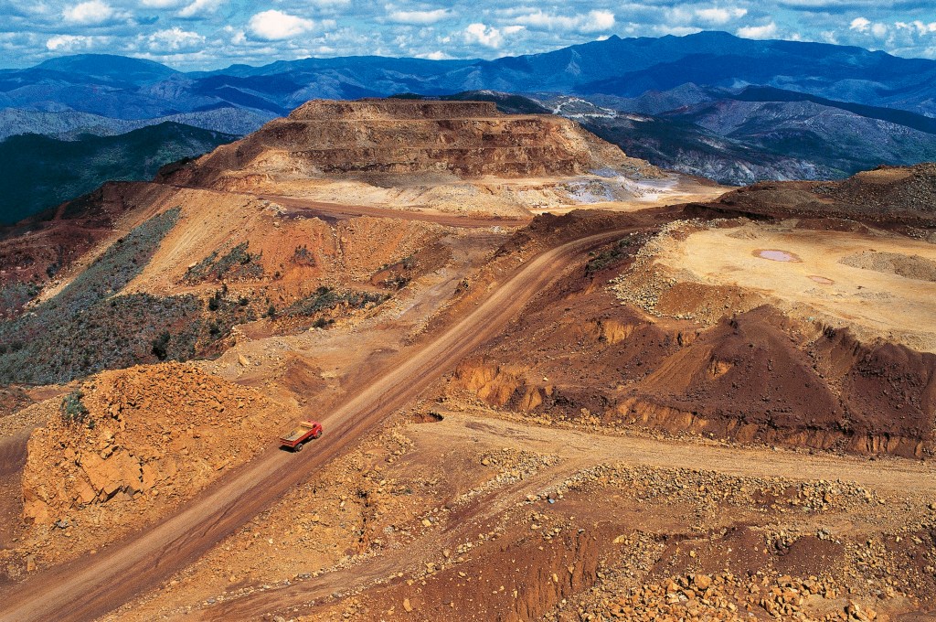 A nickel mine, shown in front of an otherwise picturesque mountain range