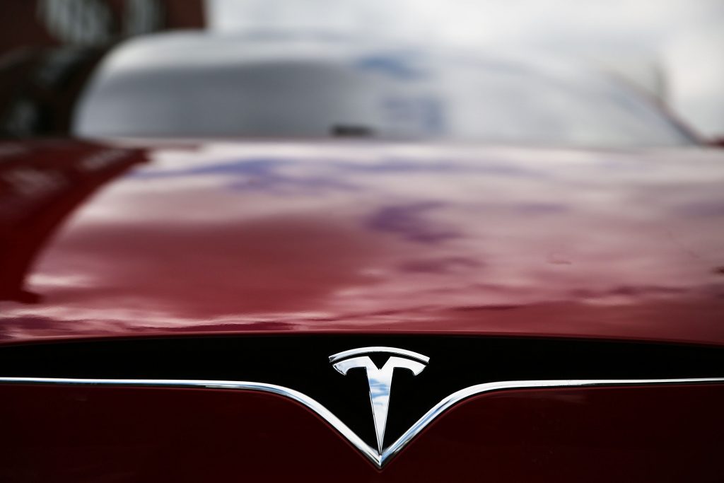 The hood of a Tesla Model S sedan in red