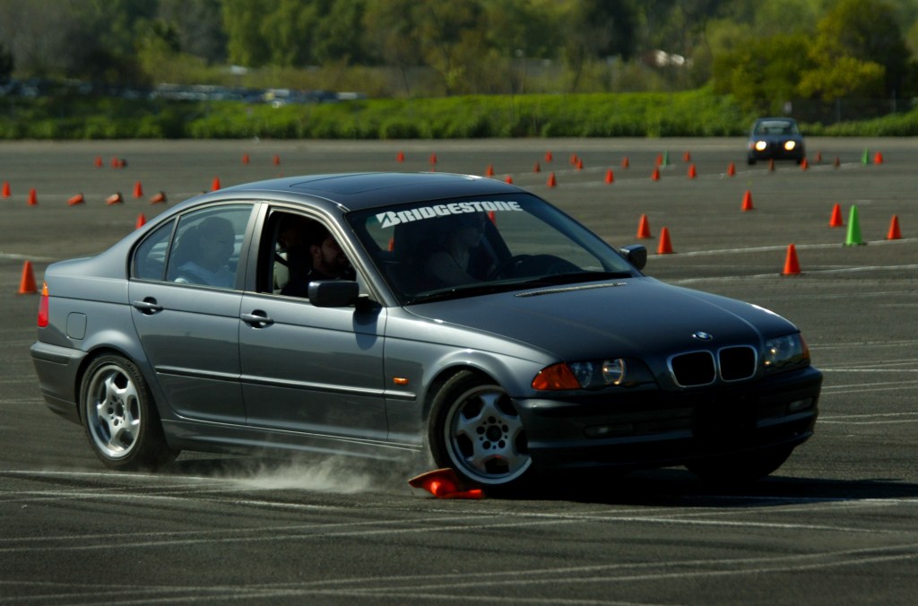 A BMW runs over a cone at an autocross course
