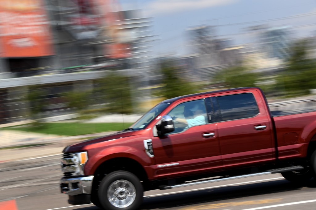 The 2021 Ford Super Duty pickup truck driving at speed 