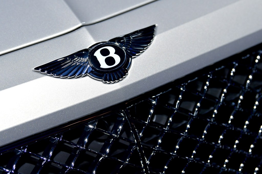 The flying "B" logo on the hood of a white Bentayga
