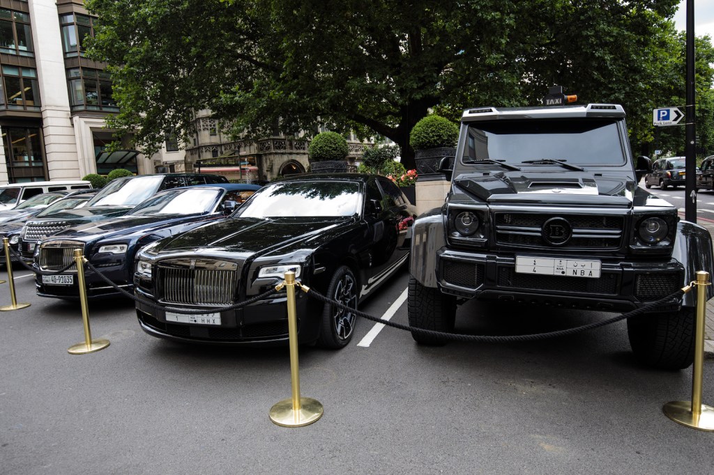 LONDON, ENGLAND - AUGUST 01: A row of cars including a Brabus (R) and two Rolls Royce sit parked outside The Dorchester hotel in Mayfair on August 1, 2017 in London, England. Each summer luxury supercars from the Arab states arrive in London and are often found parked outside the city's most exclusive hotels. (Photo by Jack Taylor/Getty Images). Read about the The Rise of The Supertruck: Brabus, Tesla, and Hummer Lead This New Exotic Truck Class