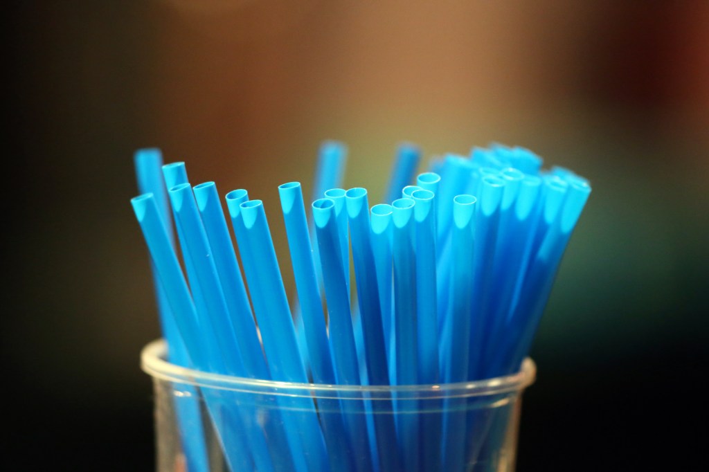Blue straws in a glass.  France. (Photo by: Godong/Universal Images Group via Getty Images). Straws are one of our do it yourself car hacks.