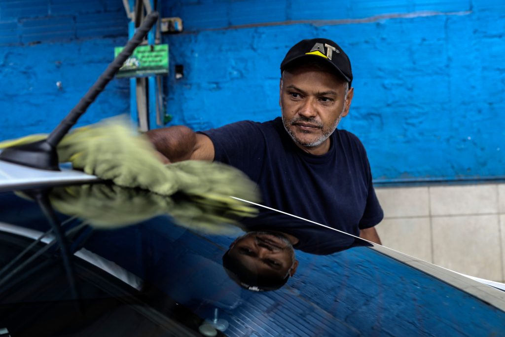 Man Dries His Car With A Microfiber Towel