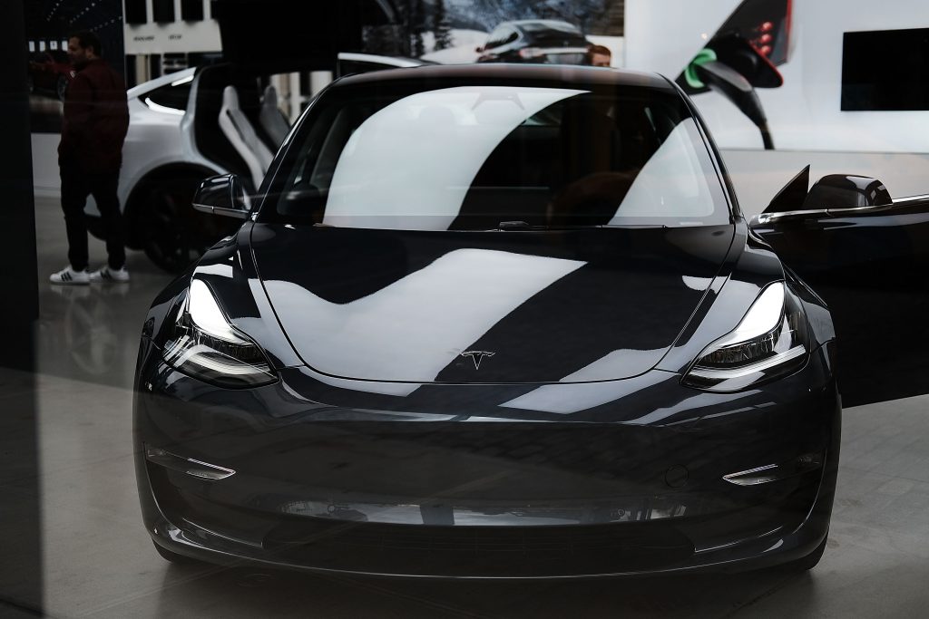 A black Tesla Model 3 in a showroom