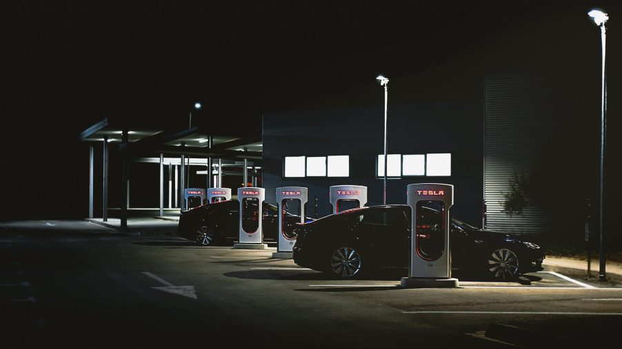 A black Tesla Model S charging at night in Barcelona