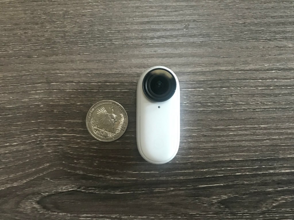 The size of the Insta360 Go 2 in relation to a quarter 