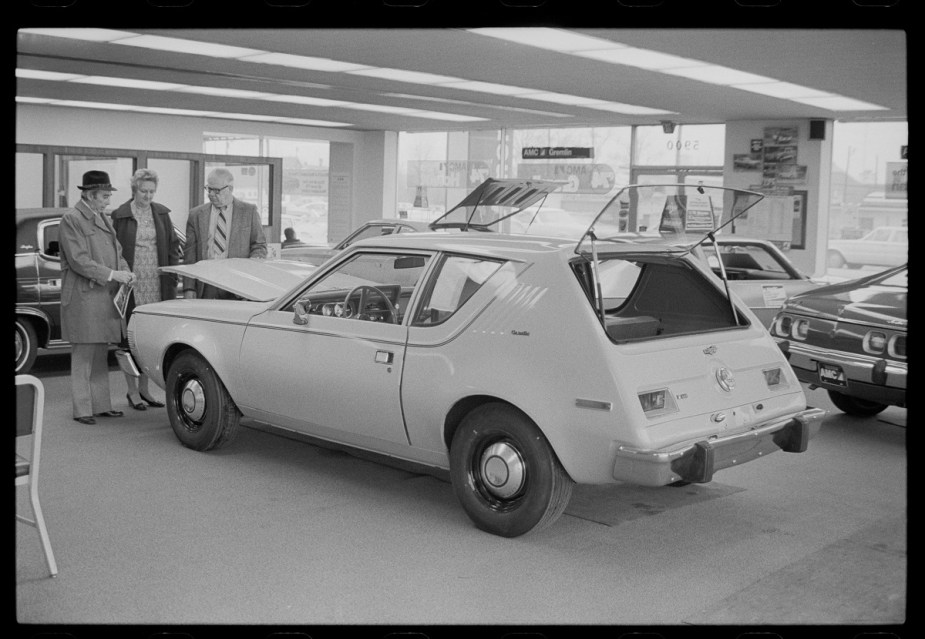A white 1970 AMC Gremlin in a garage.