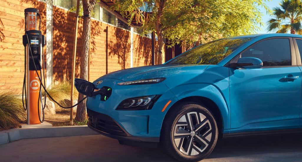 A blue Hyundai Kona Electric charging.
