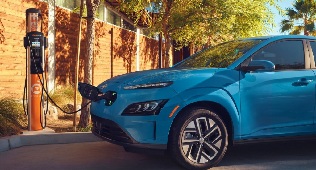 A blue Hyundai Kona Electric charging.