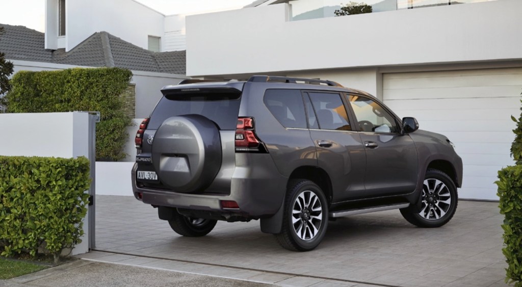 a Land Cruiser Prado in a modern driveway