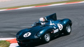 1954 Jaguar D Type roadster race car racing on a track.