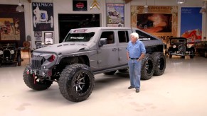Jay Leno with a gray Apocalypse Hellfire 6x6 in his garage