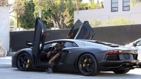 Kayne West exiting an exotic luxury car model in Los Angeles, California