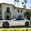 The Karma Revero GT parked in the plaza outside of a luxury villa