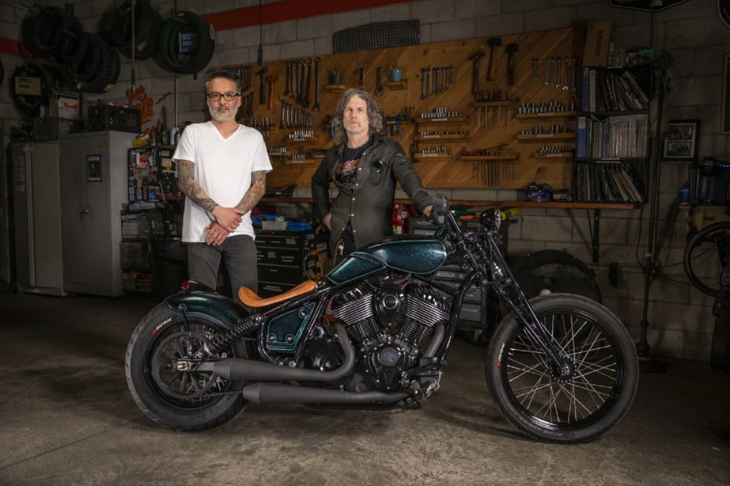 Keino Sasaki (left) and Paul Cox with their metallic-green custom 2022 Indian Chief in a garage