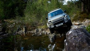 2021 Land Rover Defender 90 parked next to a lake