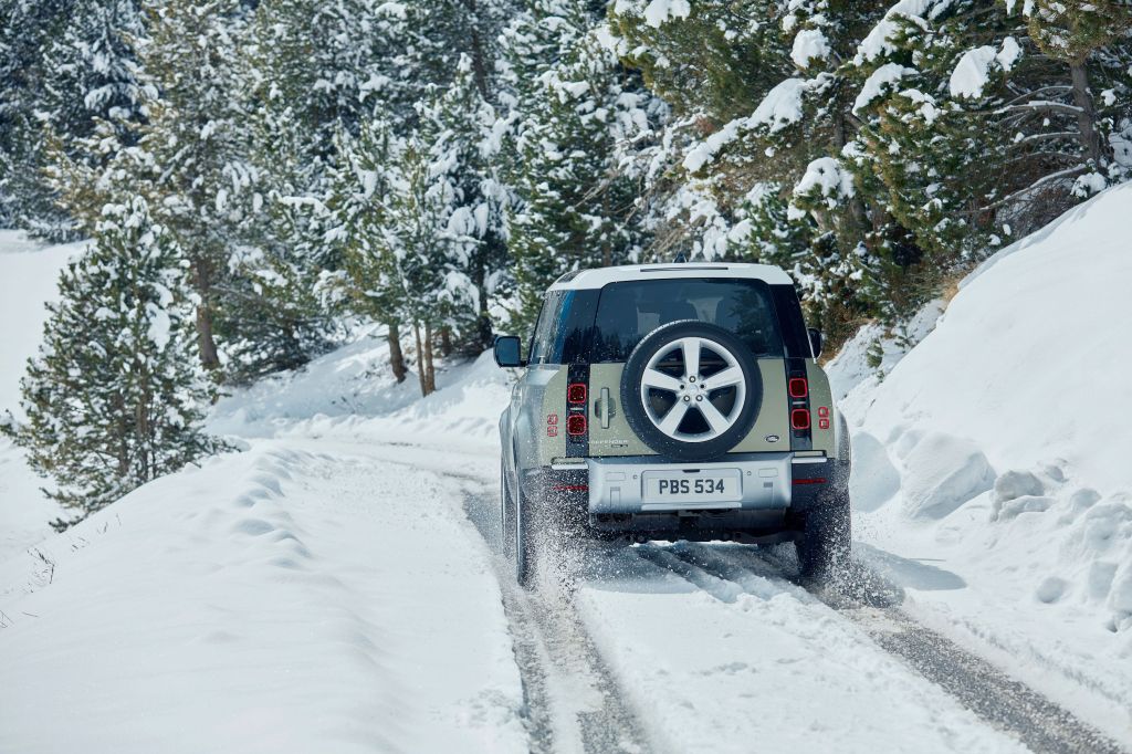 new Land Rover Defender driving through the snow