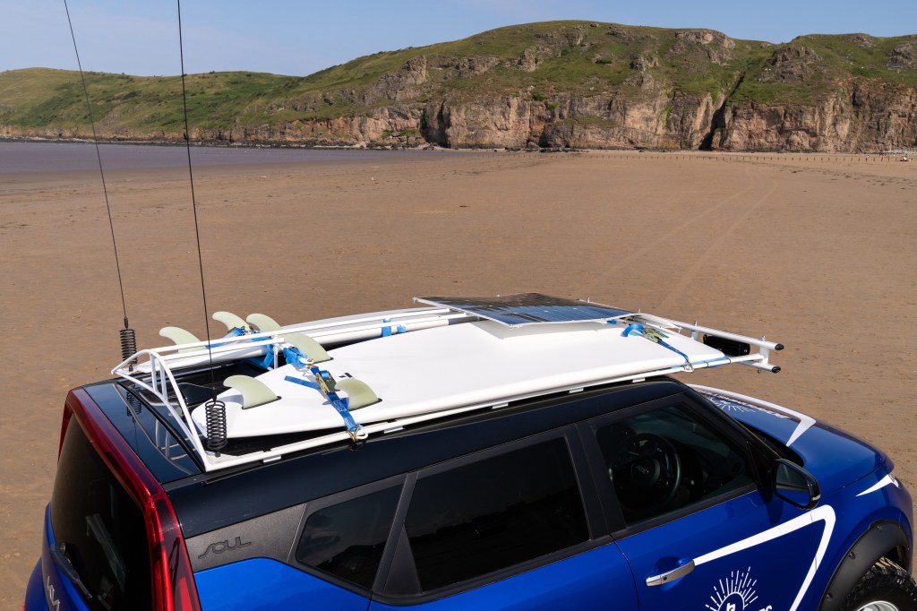 Two surfboards ratchet-strapped to the roof of the Beach EV